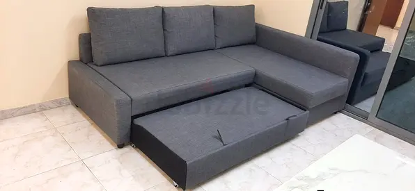 Grey L-shaped Sofa with Pull-out Bed - Good Condition
