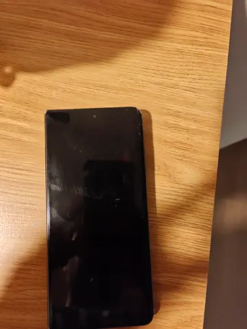 Used smartphone with cracked outer screen
