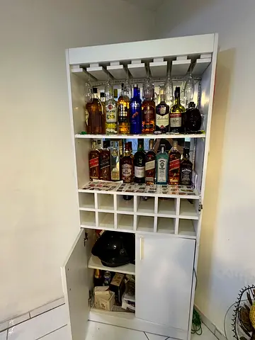 White freestanding home bar cabinet with wine racks and glass holder