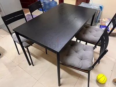 IKEA Black 4-seater dining table with metal frame and cushions