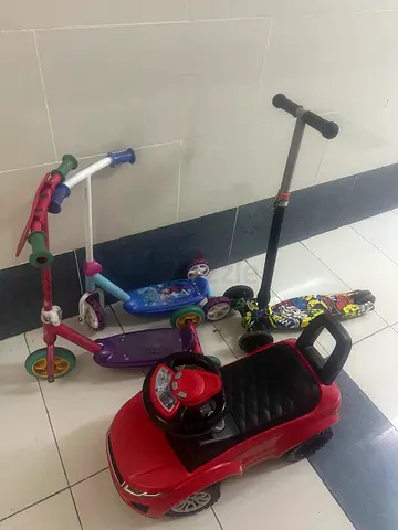 Kids ride-on car and three scooters - good condition