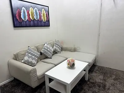 Used Light Beige L-Shaped Sofa with Cushions and Coffee Table