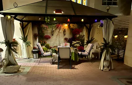 Outdoor gazebo with curtains and seating set — covered dining/patio shelter