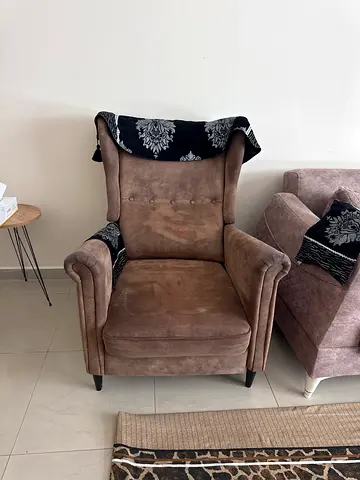 Comfortable wingback armchair in beige suede with patterned accents