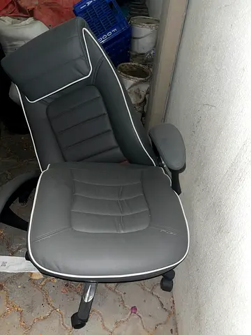 Used grey leatherette office swivel chair with armrests and headrest needs fixing
