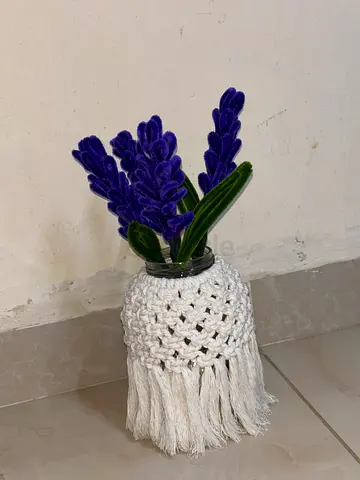 Small decorative artificial lavender plant in macrame pot cover