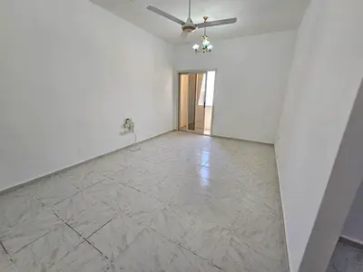 Free gym and swimming pool, two-bedroom apartment with hall in Al Nad – Al Qasimia. Fully renovated building with spacious layout, open view, and a pr