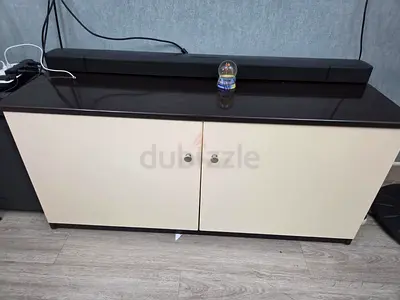 Low two-door storage cabinet with dark top (good condition)