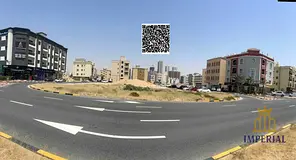 Two adjoining plots of land on a corner (G+3) on the main road opposite Al-Raqayib, freehold