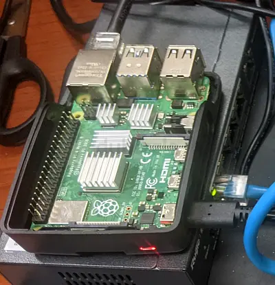 Raspberry Pi 4 Model B (in case) with heatsinks and cables - working