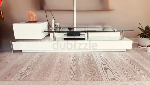 Low-profile modern Huzaifa Brand white TV unit with glass top elegant and pretty
