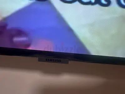 Mounted 65-inch LED TV in good working condition