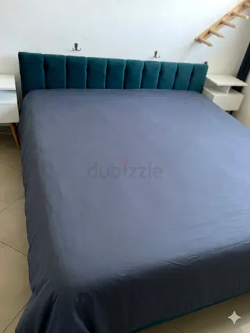 King-size upholstered bed with teal velvet headboard — good condition