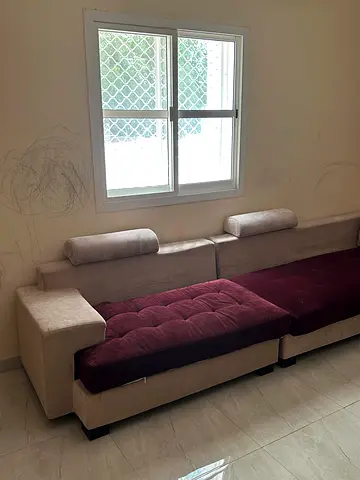 L-shaped fabric sofa in beige and maroon — used, good condition