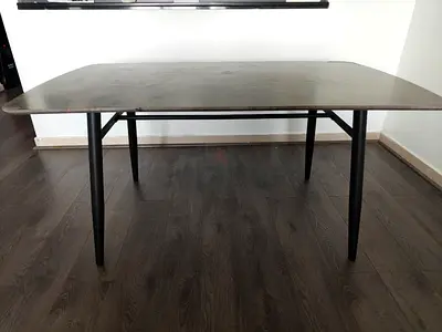 Solid wood dining table with metal legs — average condition