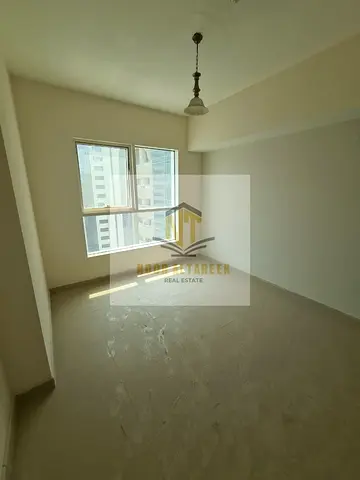 Two master bedroom apartment with a living room, gym, parking and swimming pool in the heart of Al Majaz 1, with no administrative fees and air condit