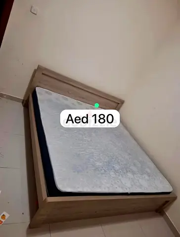 Single wooden bed frame with mattress - good condition, AED 180