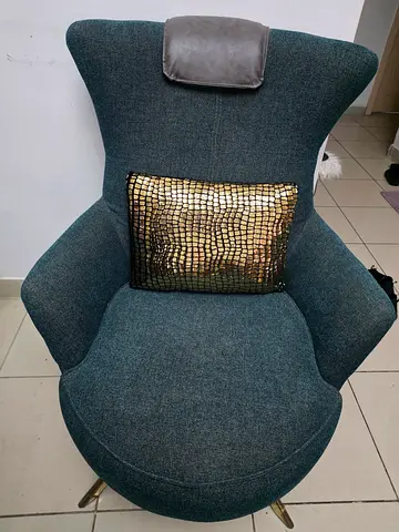 Modern teal upholstered lounge chair with matching ottoman
