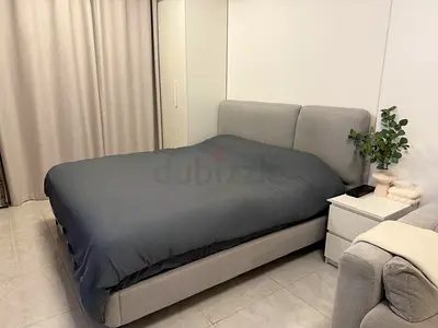 Modern gray upholstered King bed frame with padded headboard