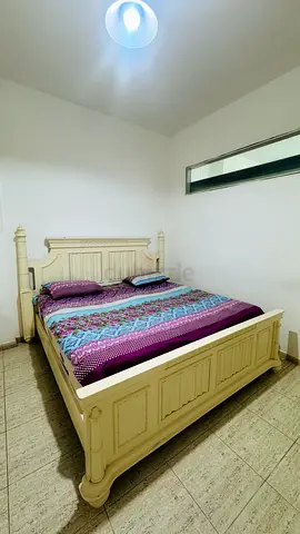 Cream wooden double bed frame with headboard and footboard