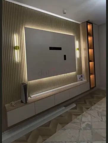 Wall-mounted entertainment center with LED backlight and display shelving