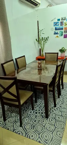 Home Center dining table with Set of 6 wooden chairs. Padded cream upholstery