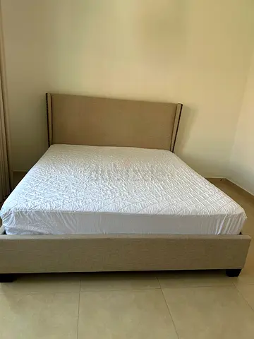 Queen beige upholstered bed frame with headboard — good condition king size