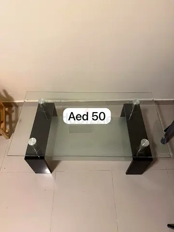 Glass Coffee Table with Black Wooden Legs - Good Condition, AED 50