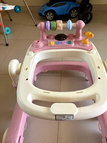 Pink baby walker with activity tray - good condition
