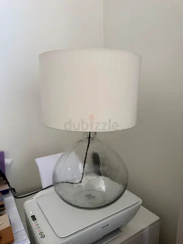 Bedside table lamp with cream fabric shade and exposed filament bulb