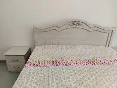 Wood-look double bed frame with matching bedside table — light beige finish