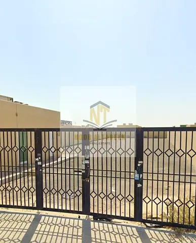 Prime ready land for sale in Al Sajaa area. A fenced industrial plot with a permit (ground + first floor), suitable for investment or industrial use,