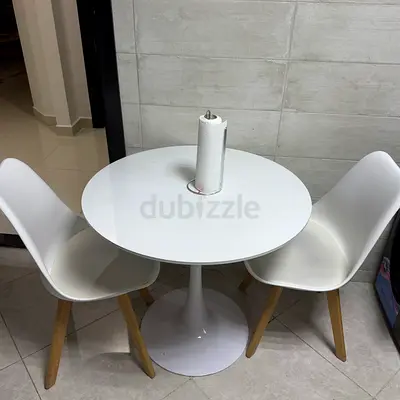 White round dining table with two modern chairs - compact set