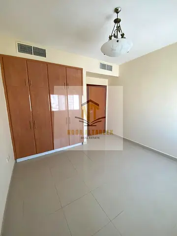 Apartment for annual rent in Abu Shagara, two bedrooms, living room, balcony, central air conditioning, central gas, no administrative fees, prime loc