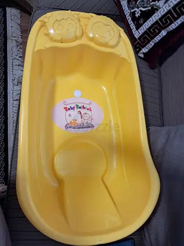 Used yellow baby bathtub - simple plastic tub in good condition