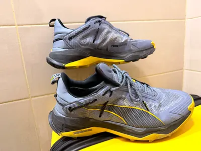 Used Puma grey  yellow running shoes size unknown - good condition