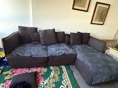 L-shaped dark grey fabric sofa with chaise, used - good condition