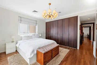 Spacious bedroom set with large wooden wardrobe and bed