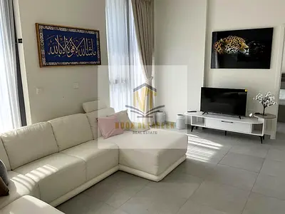 Two-bedroom apartment with a living room, fully furnished, for rent in Aljada, Sharjah, with a modern design and integrated services.