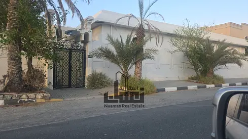 Villa for sale located in the Al Riffa area of Sharjah, featuring a generous land area of 11,449 Sq. Ft. The property is designed with a main residenc