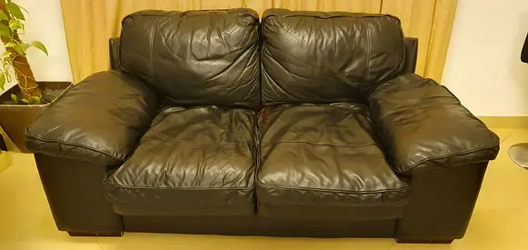 Genuine black leather 2-seater sofa in good condition