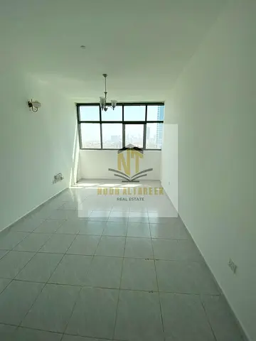 Apartment for annual rent in Abu Shagara. One bedroom and living room. Free air conditioning. No administrative fees. Prime location close to services