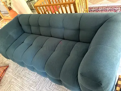 Chattles and More petrol blue upholstered 3-seater sofa in nearly brand new condition.
