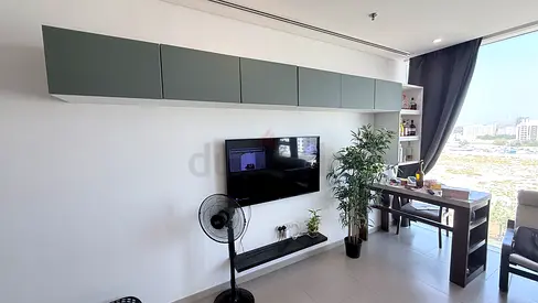 Wall-mounted TV unit with floating shelves and overhead cabinets - used