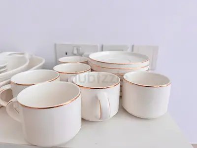 Set of white porcelain cups and saucers with gold rim - used