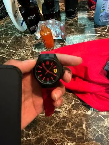 Red Ferrari-branded mens wristwatch with rubber strap