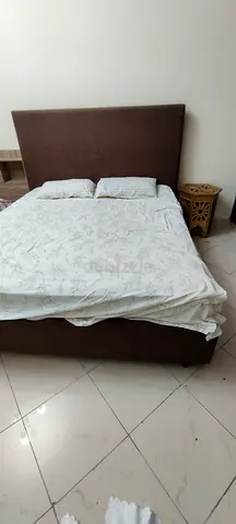 Brown fabric double bed with headboard and storage base