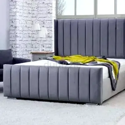 Grey upholstered king-size bed with vertical channel headboard