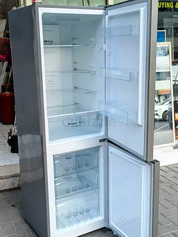 Silver double-door refrigerator with freezer bottom - good condition