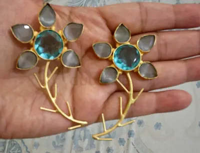Pair of floral gold-tone statement earrings with blue center stones